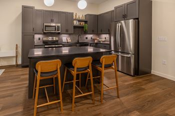 Stainless steel ge energy-star appliances including smooth cook top range, french door refrigerator with freezer door, and ultra-quiet dishwasher